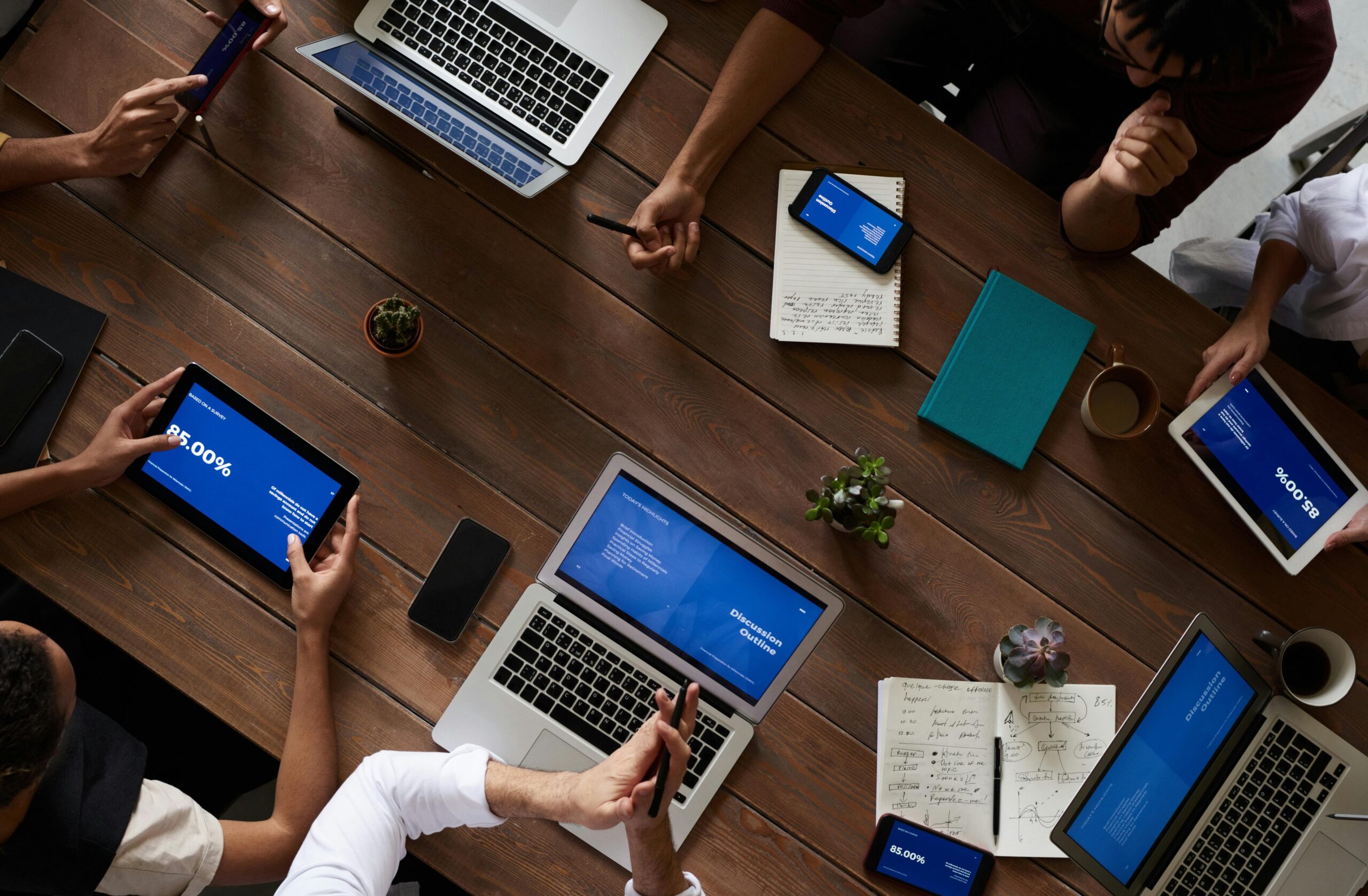 aerial view of people in a meeting with their electronic devices